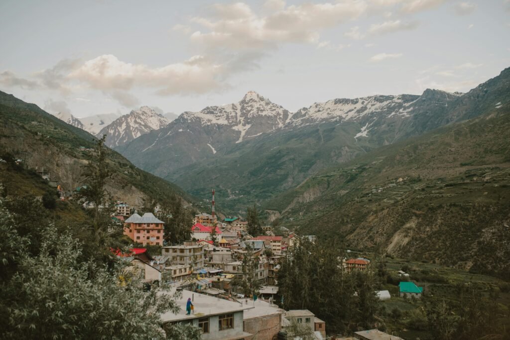 Picturesque village nestled in the Himalayan mountains of Manali, India, during a calm day.
